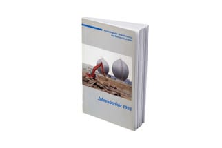 Aufgestelltes Buch mit Bild eines Baggers auf dem Cover, Jahresbericht 1998.