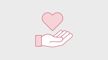 Hand mit Herz-Symbol darüber.