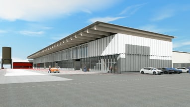 Modernes Gebäude mit Autos und Menschen auf Parkplatz bei blauem Himmel.