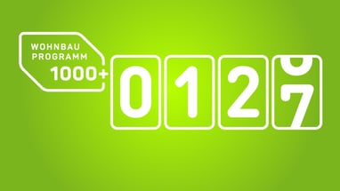 Grünes Plakat mit Zahlen und Text Wohnbauprogramm 1000+.