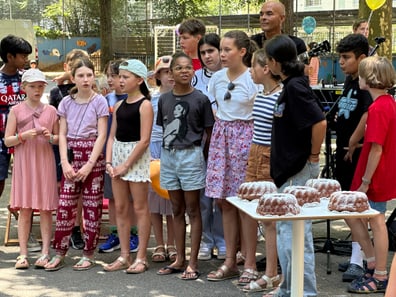 Kinderchor am Iseli-Markt mit Kuchen auf einem Tisch.