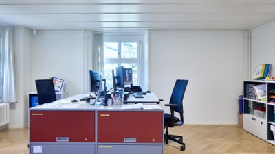 Modernes Büro mit Schreibtischen und Stühlen.