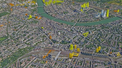 Luftaufnahme einer Stadt mit markanten gelben Gebäuden.