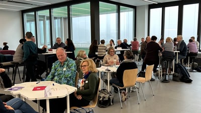 Menschen bei einer Gruppendiskussion in modernem Raum.