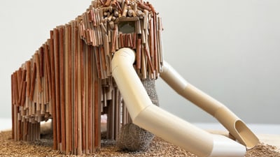 Modell eines Mammuts aus Holz und Stroh auf Holzboden.