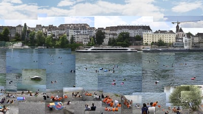 Menschen schwimmen im Rhein in Basel, mit Gebäudeansicht im Hintergrund.