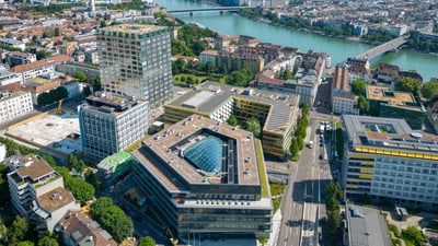 Aerial view of Basel cityscape with buildings and Rhine River.