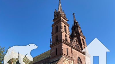 Basler Münster mit Eisbär- und Pfeil-Illustrationen.