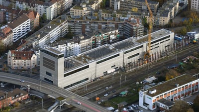 Luftbild einer städtischen Umgebung mit modernen Gebäuden und Kränen.