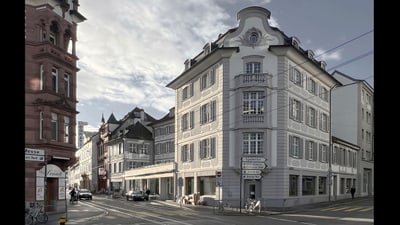 Strassenszene mit historischen Gebäuden an der Ecke.",