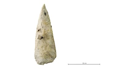 Feuersteinbeil mit Massstabslinie 10 cm.