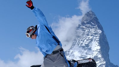 Snowboarder in front of the Matterhorn.