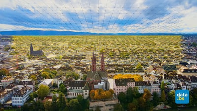 Luftaufnahme von Basel mit digitalem Netzwerkdiagramm.",