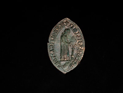 Spätmittelalterlicher Siegelstempel des Domkantors Rudolf Kraft. Er wurde im Oktober bei archäologisch begleiteten Unterwasserarbeiten am Fuss der Pfalzmauer entdeckt.